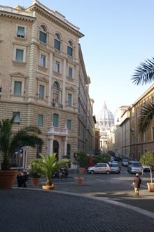 The Jesuit Headquarters in Rome, on the left, with St. Peter's in the background.  Photo by Don Doll, S.J. - Click to enlarge image.